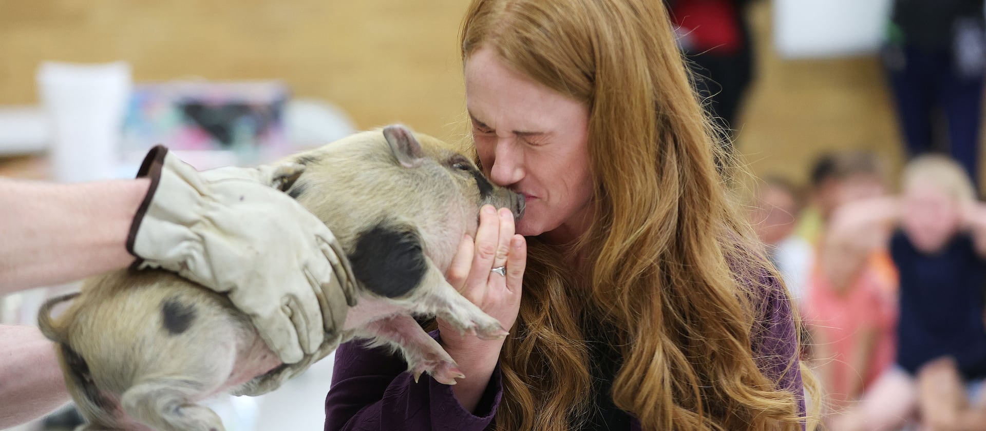 Wendy Lovell, principal of Western Hills Elementary in Kearns, kisses a piglet at the school on Wednesday, June 1, 2022.