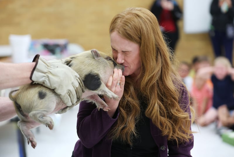 Wendy Lovell, principal of Western Hills Elementary in Kearns, kisses a piglet at the school on Wednesday, June 1, 2022.