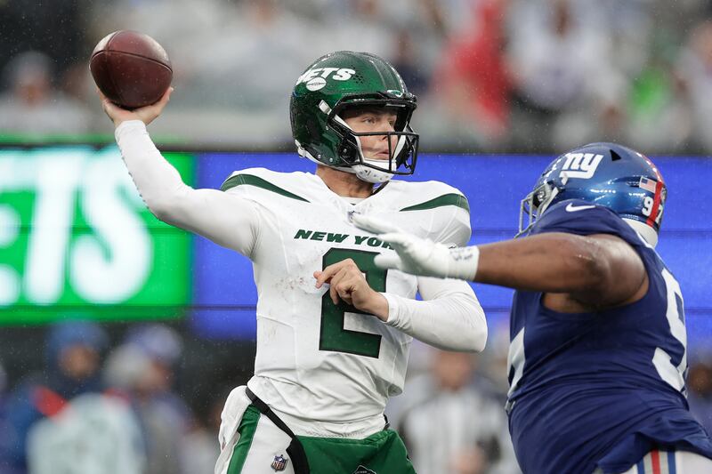 New York Jets quarterback Zach Wilson (2) passes against New York Giants defensive lineman Dexter Lawrence II (97) during the second half of an NFL football game, Sunday, Oct. 29, 2023, in East Rutherford, N.J.