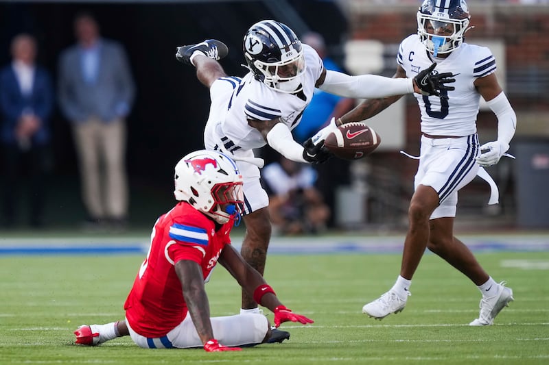BYU cornerback Marque Collins, center, breaks up a pass intended for SMU wide receiver Key'Shawn Smith during game Friday, Sept. 6, 2024, in Dallas.