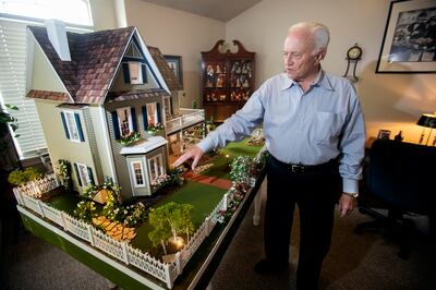 Larry Elkins shows a dollhouse he built matching the dream home he and his late wife Linda had planned to build as he talks about their life together and their family on Wednesday, March 27, 2019.