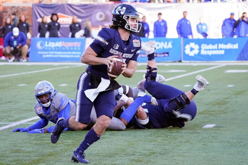 Utah State quarterback Cooper Legas runs with the ball during the second half of the First Responder Bowl.