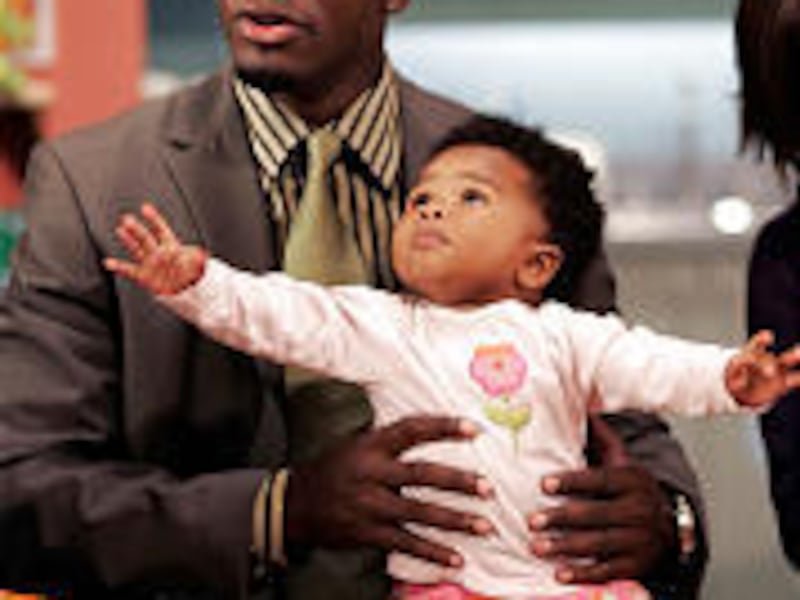 Kevin Hill (Taye Diggs) with baby Sarah on his lap in the new series.