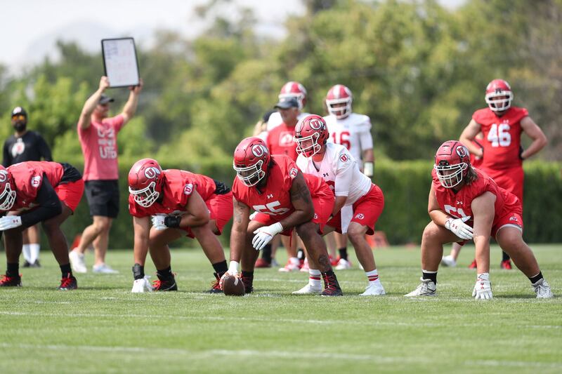 Utah quarterback Charlie Brewer lines up behind the offensive line