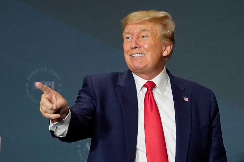 Former President Donald Trump gestures to the audience after speaking at an America First Policy Institute agenda summit.