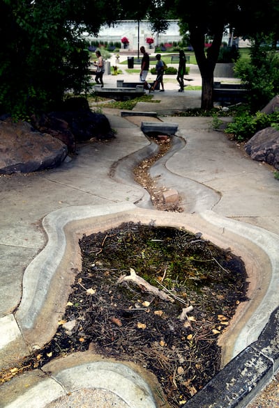 Algae and mud pools in the Seven Canyons Fountain in Liberty Park on Thursday, June 13, 2019. The fountain was closed two years ago due to health and safety concerns. The city is now working to come up with solutions and funding to reopen it.