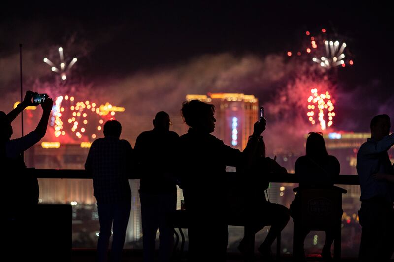 Spectators watch as fireworks explode over the Las Vegas Strip.