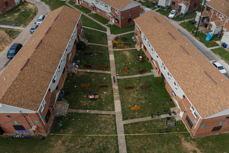 Tables are left on their side in the area of a mass shooting incident in the Southern District of Baltimore.