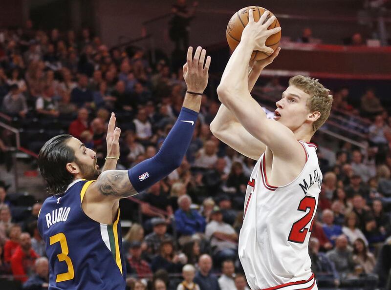 Utah Jazz guard Ricky Rubio defends as Chicago Bulls forward Lauri Markkanen (24) shoots during the first half of an NBA basketball game Wednesday, Nov. 22, 2017, in Salt Lake City. (AP Photo/Rick Bowmer)