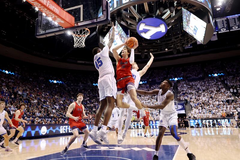 Brigham Young Cougars forward Fousseyni Traore and Brigham Young Cougars guard Spencer Johnson defend St. Mary’s Gaels guard Aidan Mahaney