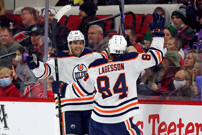 Edmonton Oilers’ Derek Ryan (10) celebrates his goal with teammate William Lagesson (84) during an NHL hockey game.