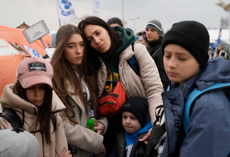 Refugees wait in a queue after fleeing the war from neighbouring Ukraine at the border crossing in Medyka, southeastern Poland, on March 29, 2022.