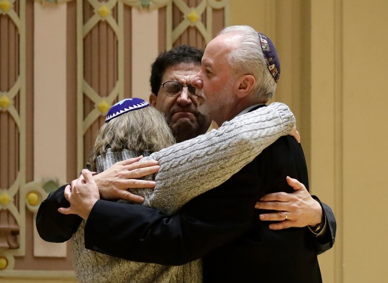 Rabbi Jeffrey Myers, right, of Tree of Life/Or L'Simcha Congregation hugs Rabbi Cheryl Klein, left, of Dor Hadash Congregation and Rabbi Jonathan Perlman during a community gathering held in the aftermath of a deadly shooting at the Tree of Life Synagogue