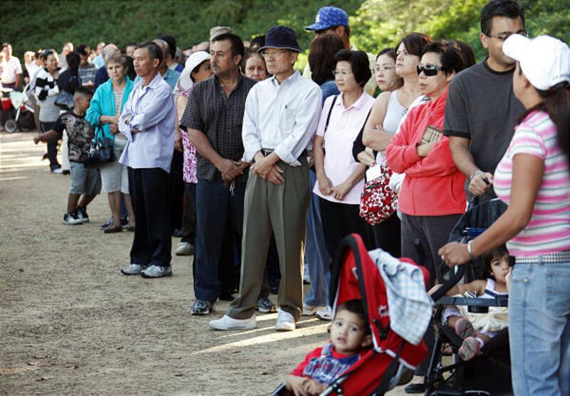 People wait for the swine flu shot in California. Some healthy adults are taking the vaccination out of order.