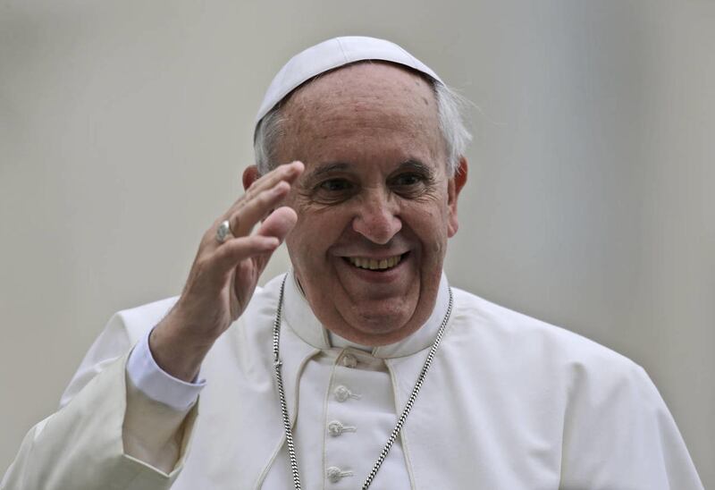 Pope Francis waves to faithful during his weekly general audience in St. Peter's Square, at the Vatican, Wednesday, Nov. 13, 2013.