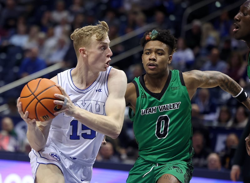 BYU guard Richie Saunders drives past Utah Valley’s Justin Harmon at the Marriott Center in Provo on Wednesday, Dec. 7, 2022.