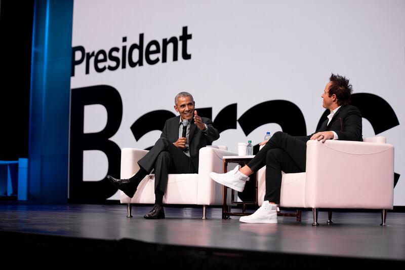 Qualtrics CEO Ryan Smith sits with former President Barack Obama during the company’s annual user summit in March 2019.