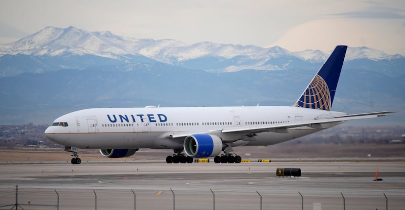 A United Airlines jetliner taxis to a runway for take off from Denver International Airport on Dec. 27, 2022.