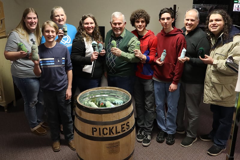 Volunteers in Lebanon, Missouri, donate crocheted pickles and a pickle barrel to Live 2 Give Hope, a local charity that provides free resources to foster, guardianship and adoptive families, in January 2025.