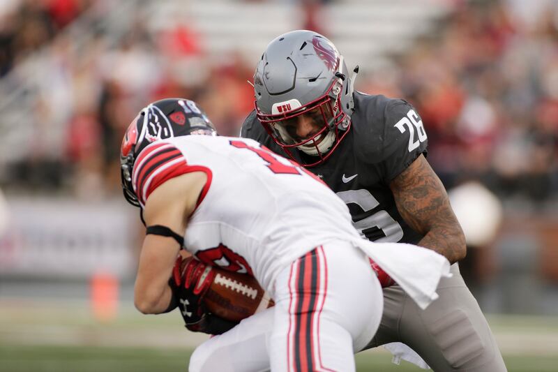 Washington State defensive back Hunter Dale (26) tackles Utah wide receiver Britain Covey during the second half of an NCAA college football game in Pullman, Wash., Saturday, Sept. 29, 2018. (AP Photo/Young Kwak)