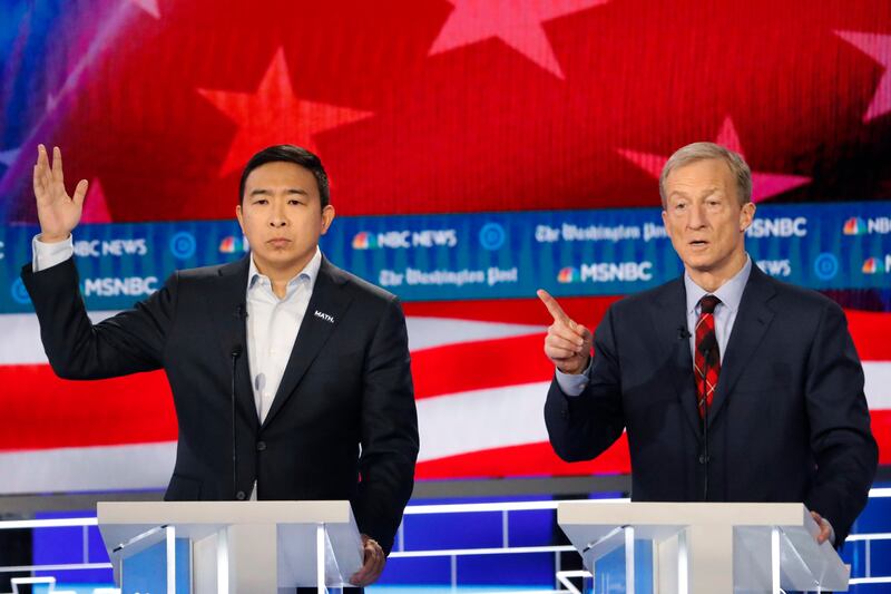 Democratic presidential candidate investor Tom Steyer speaks as Democratic presidential candidate former technology executive Andrew Yang motions during a Democratic presidential primary debate, Wednesday, Nov. 20, 2019.