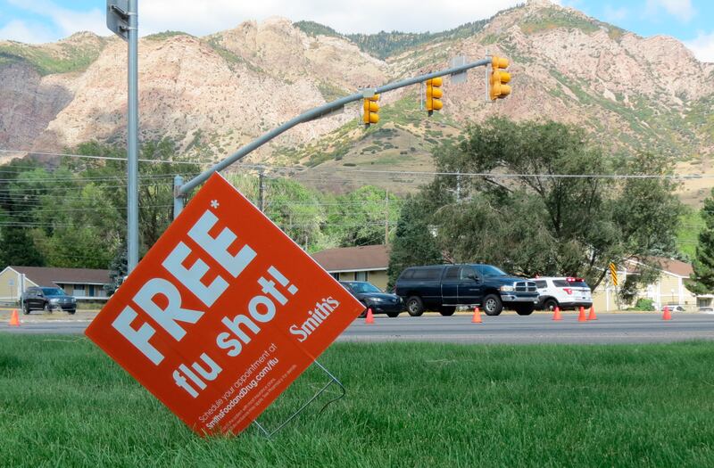 A sign advertising flu shots is displayed on Tuesday, Sept. 8, 2020, in Ogden, Utah. The annual flu season is gearing up alongside the coronavirus pandemic, and Utah health officials are encouraging people to get their flu shots.