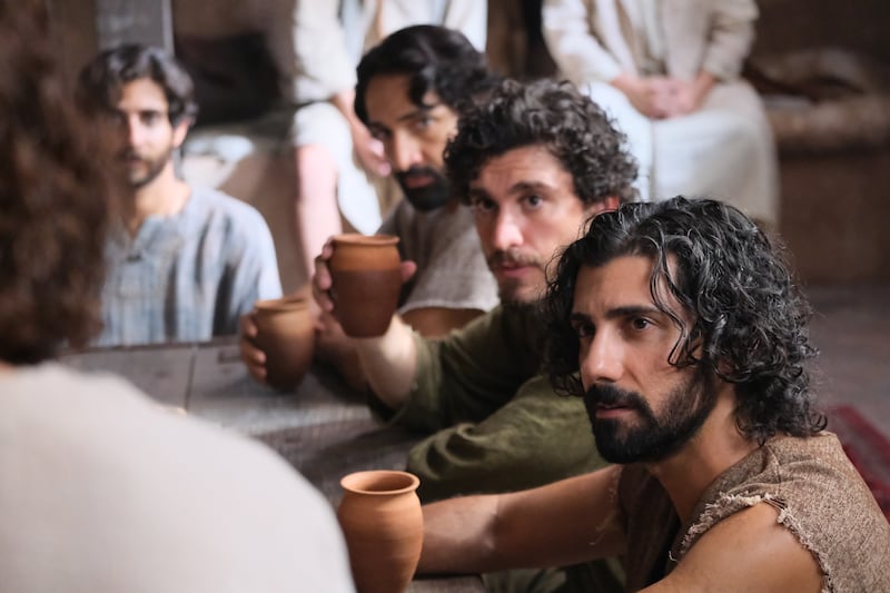 Andrew (Noah James), John (George Xanthis) and other apostles listen to Jesus (Jonathan Roumie) in a scene from Season 3 of “The Chosen.”