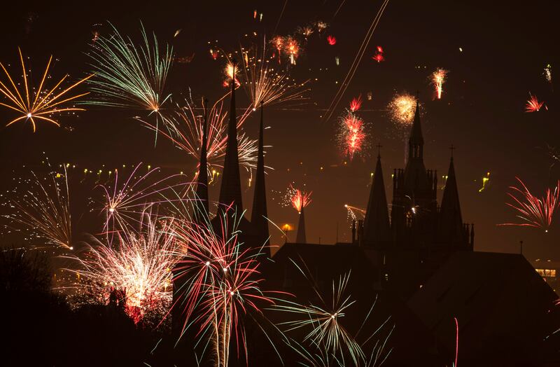New Year’s fireworks go off in the sky above two churches in Erfurt, Germany.