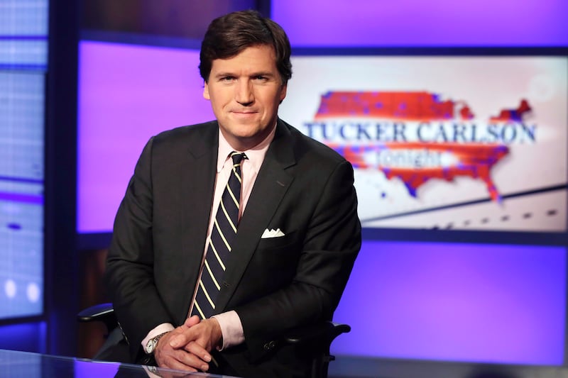 Tucker Carlson poses for photos in a Fox News Channel studio in New York on March 2, 2017.