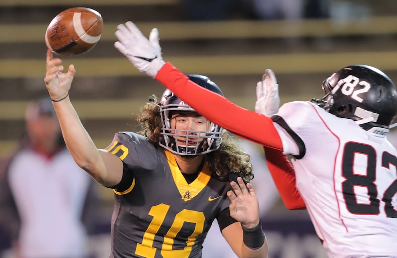 Summit Academy quarterback Kasey Briggs passes over North Sanpete's Kout Mayoul during play in the 3A state football championship at Weber State's Stewart Stadium in Ogden on Saturday, Nov. 10, 2018. Summit Academy won 55-18.