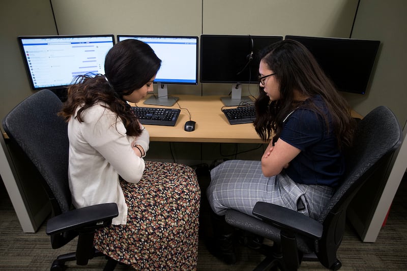Sister Megan Pazos and Sister Kimeme Ackley pray before working in the Temple Square Online Teaching Center at the Temple Square North Visitors’ Center in Salt Lake City on Thursday, March 8, 2018.