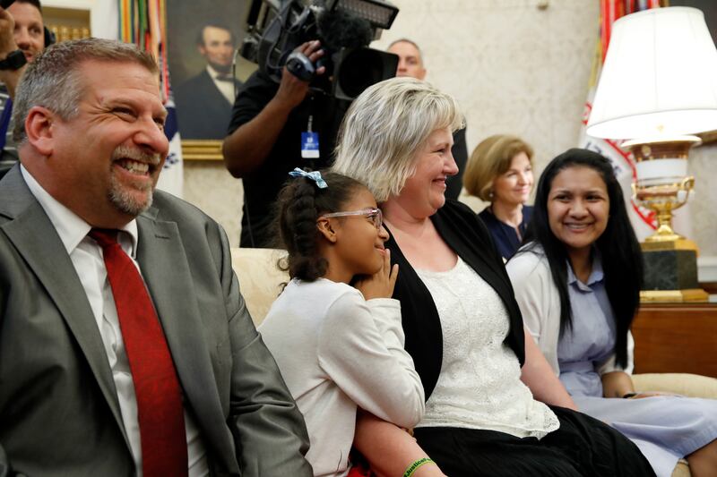 The family of Joshua Holt, who was recently released from a prison in Venezuela, father Jason Holt, left; daughter, Marian Leal; mother, Laurie Holt, and his wife, Thamara Holt, right, sit on a couch in the Oval Office of the White House during a news con