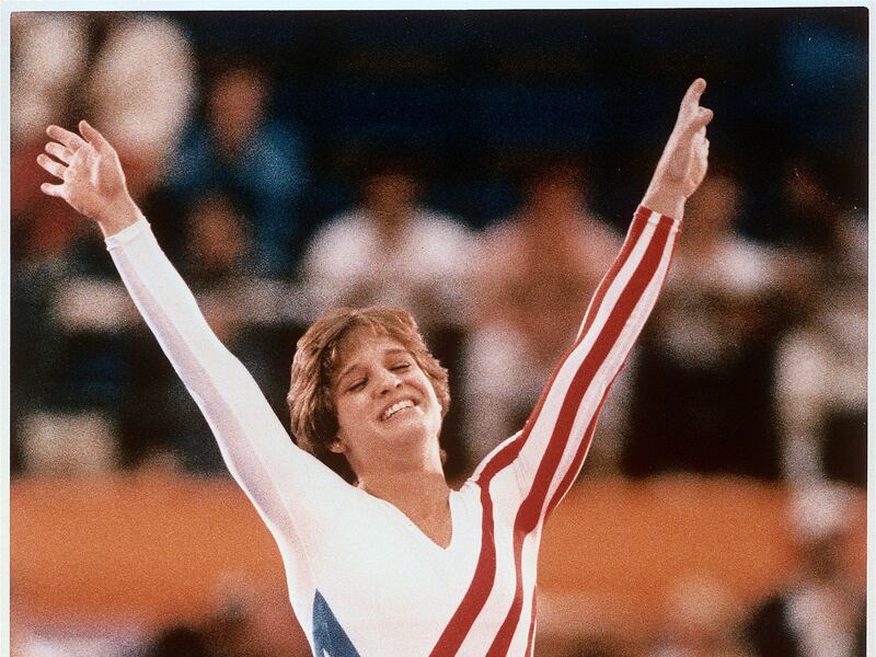 Mary Lou Retton celebrates her balance beam score at the 1984 Olympic Games in Los Angeles on Aug. 3, 1984.