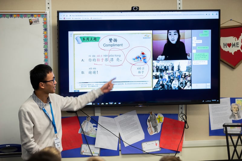 Intern Jiewen “Duke" Wu helps students at Fremont Elementary School in Sunset as online tutor “Jenny” teaches them Mandarin on Monday, Jan. 14, 2019. Once a week, students receive live online training from tutors from Qiao Qiao Chinese, which is based in