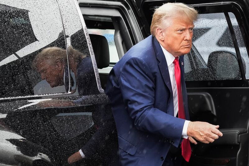 Former President Donald Trump arrives to board his plane at Ronald Reagan Washington National Airport in Arlington, Va.