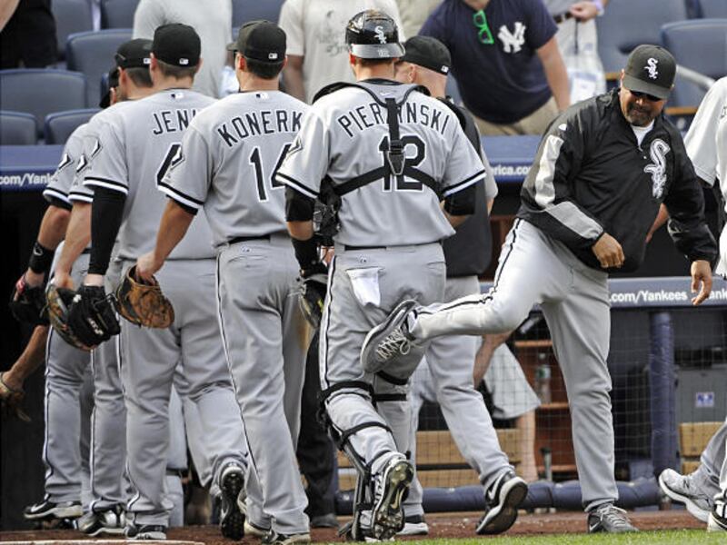 White Sox manager Ozzie Guillen, right, playfully kicks catcher A.J. Pierzynski.