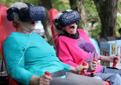 Gloria Bird, 70, and Barbara Sollie, 95, react to “Montezuma's Treasure Ride,” an Innovative Entertainment virtual reality motion ride, at Cove Point Retirement Community in Provo on Wednesday, Aug. 22, 2018.