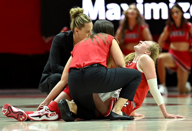 Utah Utes guard Gianna Kneepkens (5) grimaces in pain after being injured at the Huntsman Center in Salt Lake City on Dec. 2, 2023.