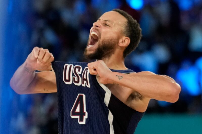 United States' Stephen Curry (4) celebrates after beating France to win the gold medal during a men's gold medal basketball game at Bercy Arena at the 2024 Summer Olympics, Saturday, Aug. 10, 2024, in Paris, France.