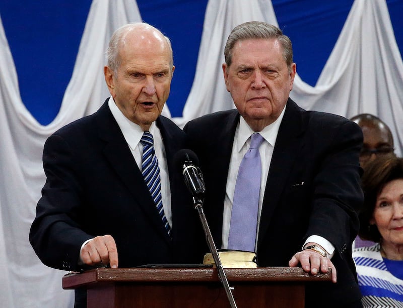 President Russell M. Nelson and Elder Jeffrey R. Holland of The Church of Jesus Christ of Latter-day Saints stand together as President Nelson gives a blessing during a special devotional in Nairobi, Kenya, on Monday, April 16, 2018.
