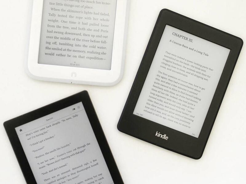 This Thursday, Dec. 19, 2013 photo shows a Nook GlowLight, top, a Kindle Paperwhite, right, and a Kobo Aura, in New York.