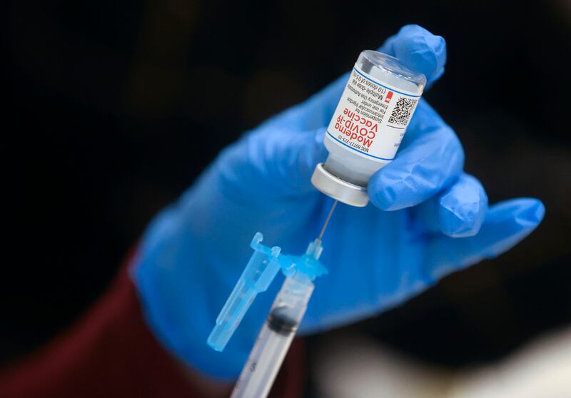 A health care worker fills a syringe with the Moderna COVID-19 vaccine at the Utah Islamic Center in West Jordan on Thursday, March 18, 2021.
