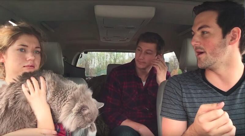 Millicent Phillips holds onto her cat as her brothers convince her the zombie apocalypse is happening.