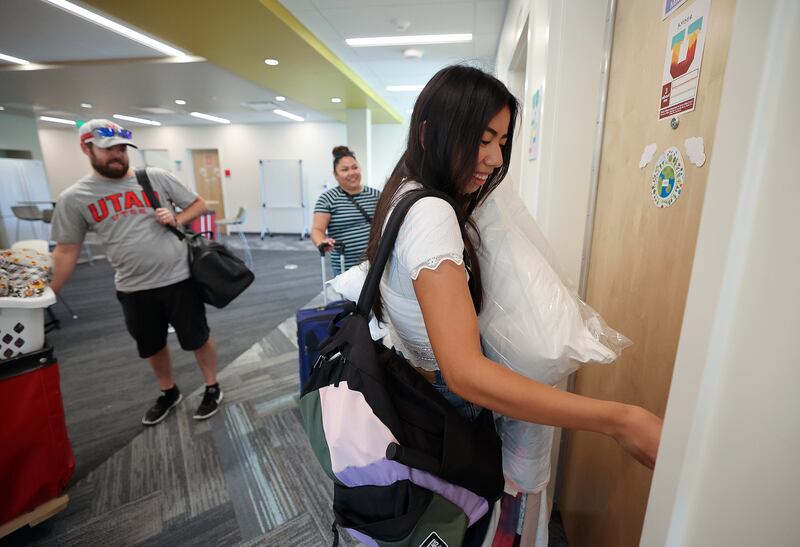 Amber San Miguel unlocks her dorm room as she moves into the University of Utah student housing on Aug. 16, 2023.