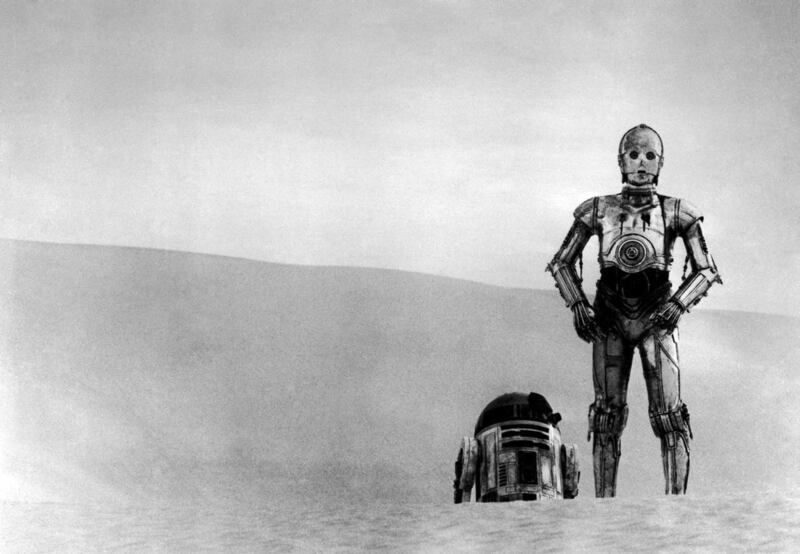 In this image provided by 20th Century-Fox Film Corporation, a scene from “Star Wars” movie released by 20th Century-Fox in 1977, shows C-3PO and R2-D2 trudge across the Tatooine desert in search of Ben Kenobi.