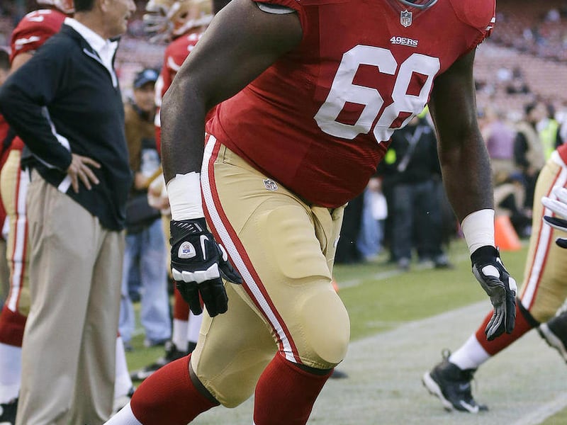 In this Aug. 30, 2012, photo, San Francisco 49ers guard Leonard Davis (68) practices before an NFL preseason football game against the San Diego Chargers in San Francisco. Davis is one of the NFL's biggest men today because his parents, both widowers, fou