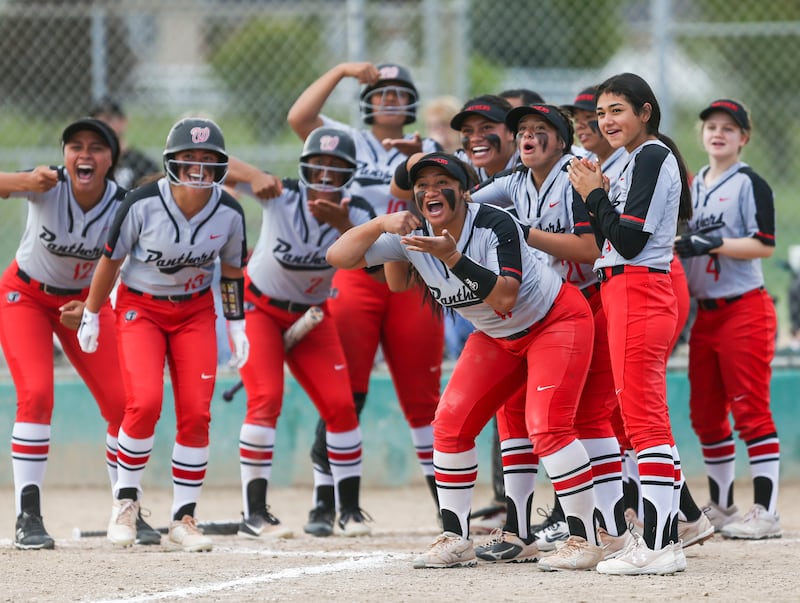 The West High School softball team waits for Huntyr Ava (54) at home plate after she hit a home run against Bountiful High School during the 5A softball championship at the Valley Regional Softball Complex in Salt Lake City on Thursday, May 30, 2019.
