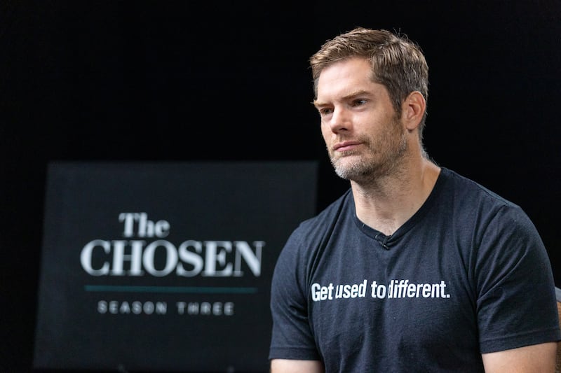 Dallas Jenkins speaks to a news reporter.