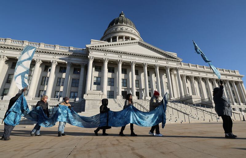 Members of the Great Salt Lake vigil group walk the grounds of the Capitol in Salt Lake City.