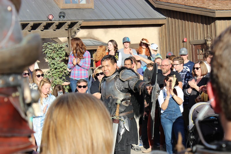 Utah Attorney General Sean Reyes shows off his armor as he addresses a crowd dressed as a "dark knight" on Evermore's opening day, Sept. 29, 2018.